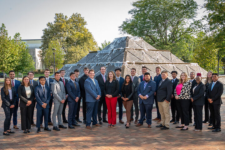 Group of real estate students stand in front of Wood Fountain on IU Indy campus.